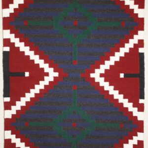 Colorful geometric patterned textile with zigzag and diamond shapes.