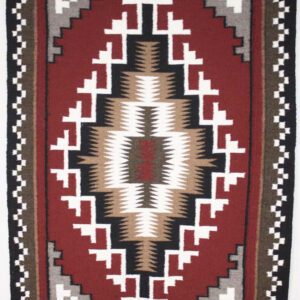 Geometric patterned textile with earthy tones in a symmetrical design.