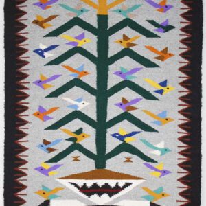 Colorful woven tapestry with tree and bird motifs.
