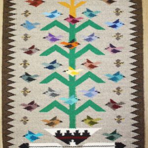 Colorful geometric patterned rug with birds and arrow motifs.