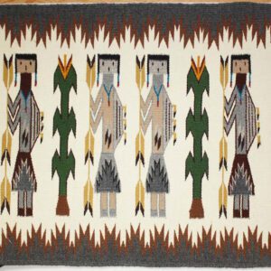 Traditional Native American woven rug with human and tree motifs.