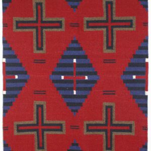 A textile with red, navy, and black geometric cross patterns.