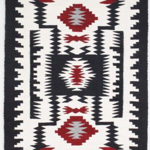 Black, white, and red geometric patterned textile with symmetrical designs.