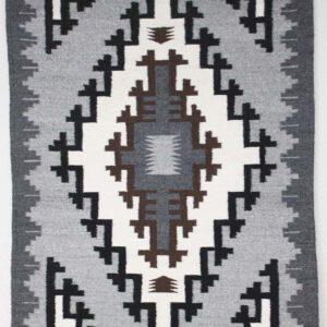 Geometric patterned textile with grayscale and brown tones.