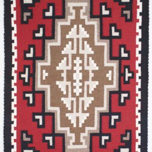Intricate geometric patterns in red, beige, and black on a woven textile.