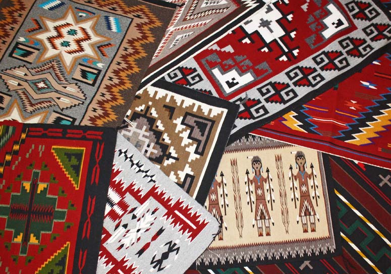 Colorful woven rugs with geometric patterns.